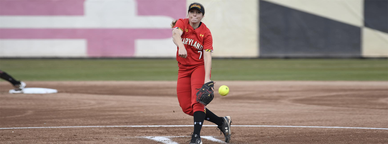 This is an image of a camp coach pitching during a practice game as part of College Camp Consulting to help coaches learn and improve in managing the actual game.