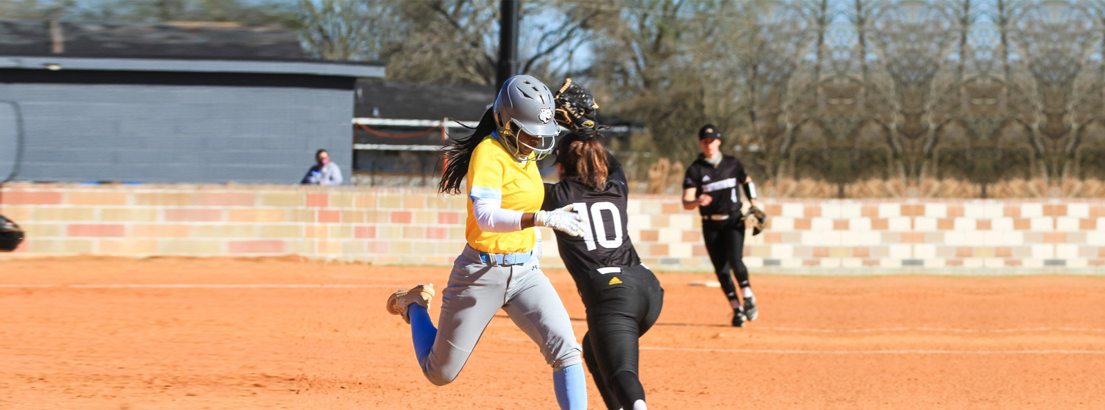 This is an image of a camp coach running bases as part of College Camp Consulting to help coaches learn and improve in managing the actual game.