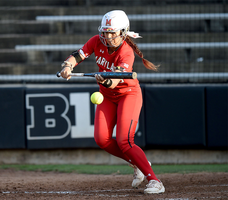 This image is of a camp coach for College Camp Consulting, educating attending coaches on how to best bunting skills and how to manage camps with these drills.