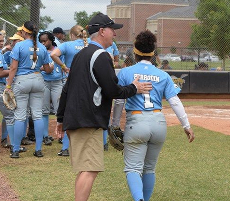 This is an image of Coach John Garris helping one of his camp player / coaches by teaching her how to best manage camps and the campers that attend the camps.