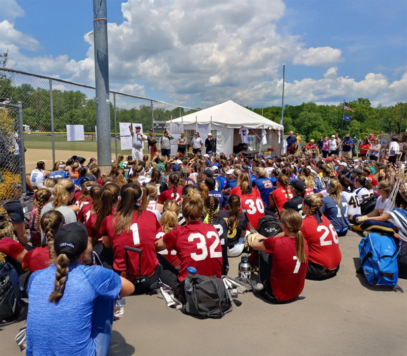 An image of coaches and campers at a College Camp Consulting event discussing the full day of camp and educating the visiting coaches on how to improve their manage camps skills.